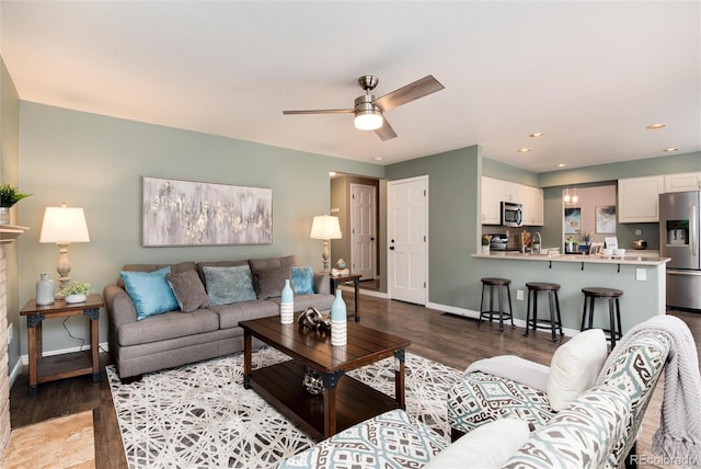 living area with recessed lighting, baseboards, a ceiling fan, and wood finished floors