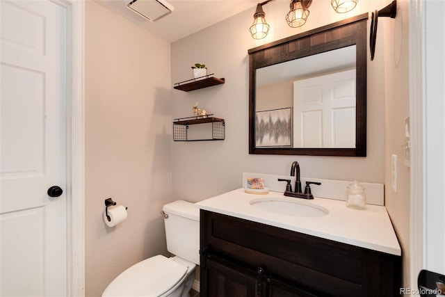 bathroom featuring toilet and vanity