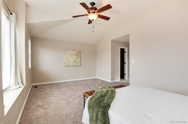 bedroom with baseboards, ceiling fan, carpet flooring, and vaulted ceiling