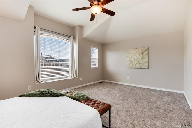 carpeted bedroom featuring lofted ceiling, baseboards, and ceiling fan