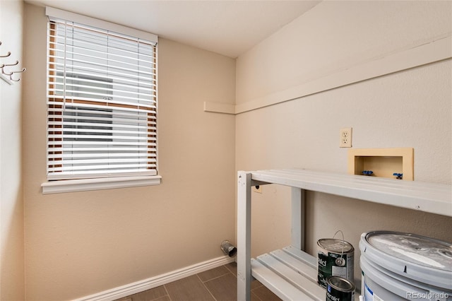 washroom featuring baseboards, washer hookup, and laundry area