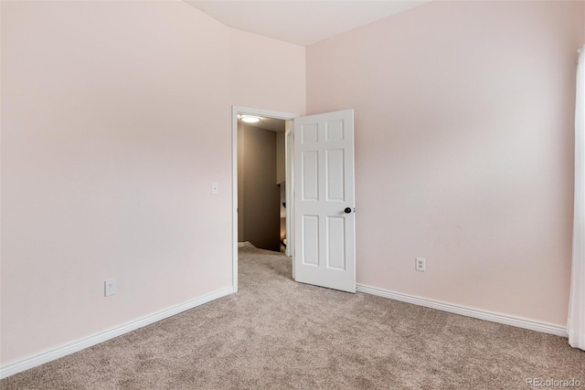 empty room with light carpet and baseboards