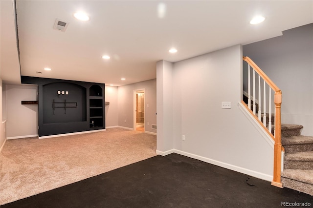 below grade area with visible vents, dark carpet, recessed lighting, stairway, and baseboards