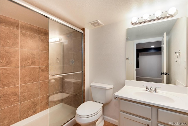 full bath featuring vanity, toilet, visible vents, and a stall shower