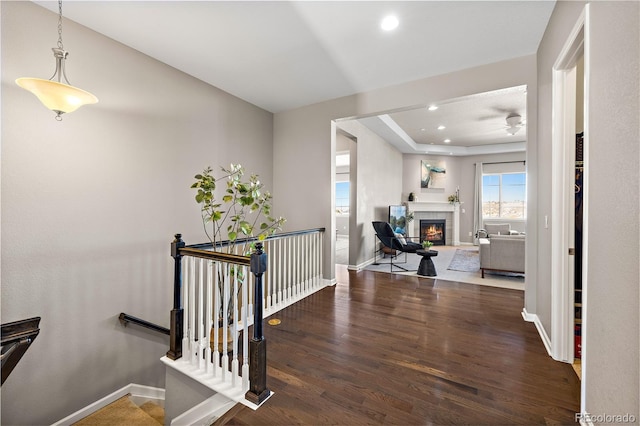 office with recessed lighting, baseboards, wood finished floors, and a tile fireplace