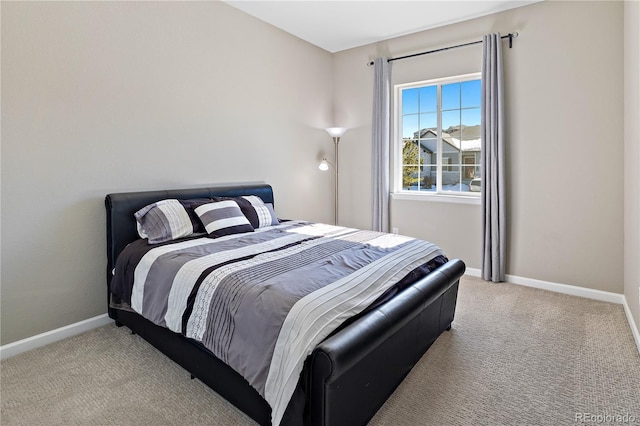 bedroom with baseboards and light carpet