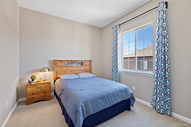 bedroom featuring baseboards and carpet