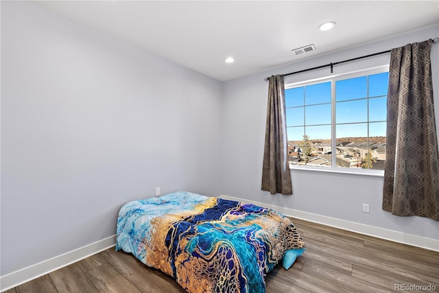 bedroom featuring wood finished floors, recessed lighting, baseboards, and visible vents