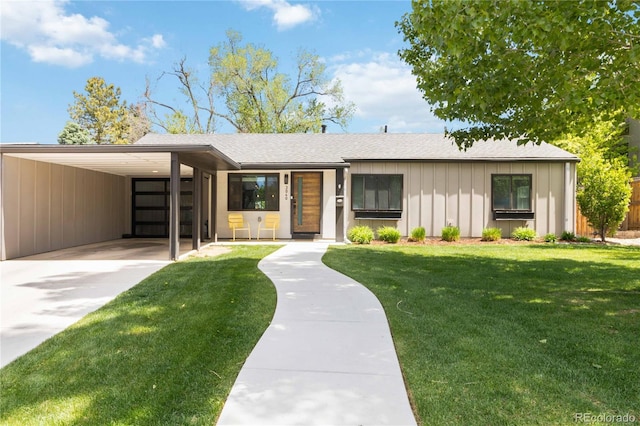 3040 S Dexter Way, Denver, CO 80222 - view of front of property featuring concrete driveway, a front lawn, board and batten siding, a carport, and roof with shingles