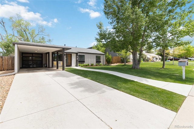 3040 S Dexter Way, Denver, CO 80222 - view of front of house featuring driveway, a carport, and board and batten siding