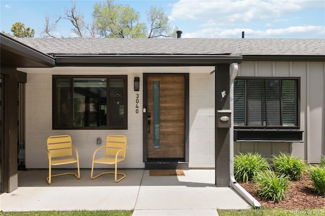 3040 S Dexter Way, Denver, CO 80222 - entrance to property with roof with shingles and board and batten siding