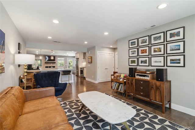 3040 S Dexter Way, Denver, CO 80222 - living area featuring dark wood-type flooring, baseboards, and recessed lighting