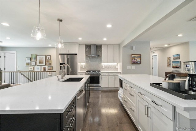 3040 S Dexter Way, Denver, CO 80222 - kitchen featuring stainless steel appliances, a spacious island, wall chimney exhaust hood, a sink, and tasteful backsplash
