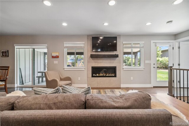 3040 S Dexter Way, Denver, CO 80222 - living room featuring baseboards, recessed lighting, wood finished floors, and a large fireplace