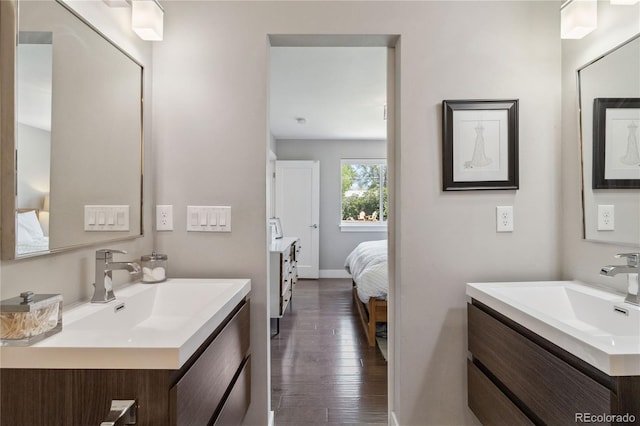 3040 S Dexter Way, Denver, CO 80222 - ensuite bathroom with wood-type flooring, two vanities, and baseboards