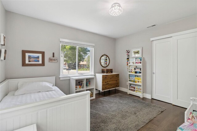 3040 S Dexter Way, Denver, CO 80222 - bedroom with dark wood-style floors, a closet, and baseboards