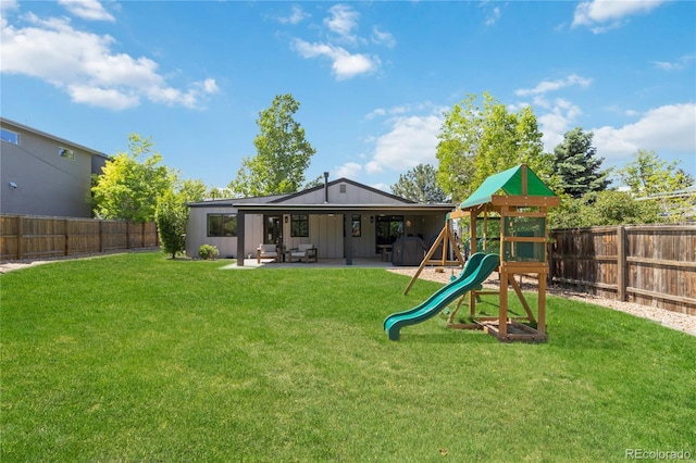 3040 S Dexter Way, Denver, CO 80222 - back of house featuring a playground, board and batten siding, and a patio area