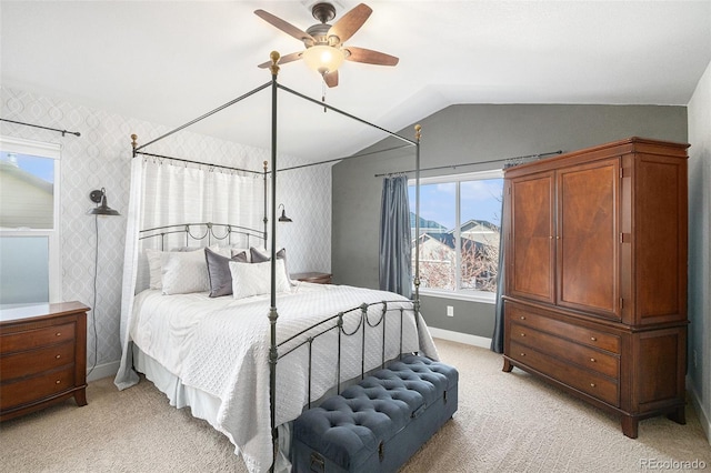 bedroom with wallpapered walls, baseboards, vaulted ceiling, and light colored carpet