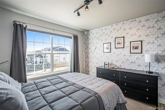 bedroom featuring carpet, a textured ceiling, and wallpapered walls