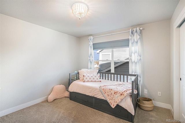 carpeted bedroom featuring baseboards