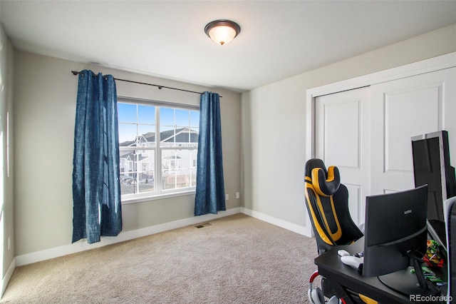 home office featuring carpet floors, visible vents, and baseboards