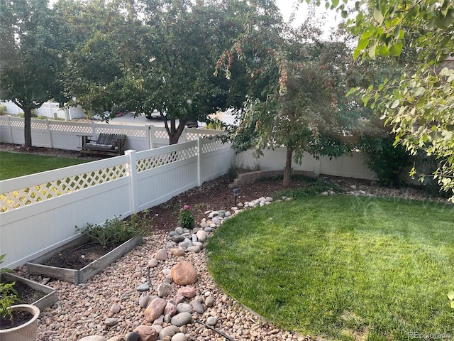 view of yard featuring a fenced backyard and a vegetable garden