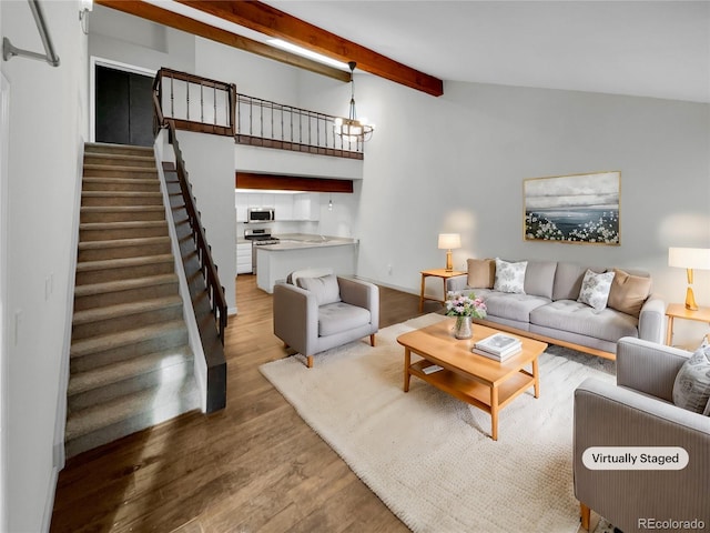 living room featuring wood-type flooring, beam ceiling, and a chandelier