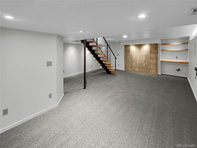 basement with a textured ceiling and carpet flooring