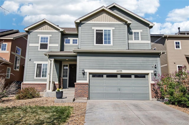 craftsman-style house with brick siding, a garage, board and batten siding, and concrete driveway