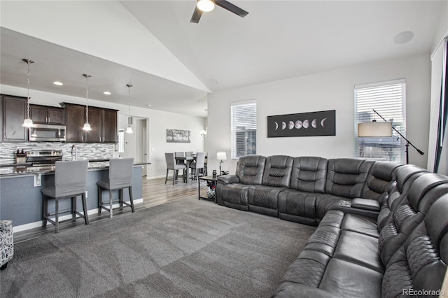 living room featuring recessed lighting, a ceiling fan, lofted ceiling, and a healthy amount of sunlight