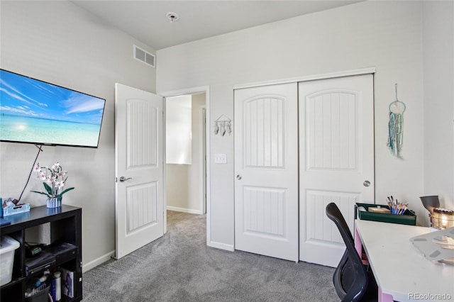 carpeted office space with visible vents and baseboards