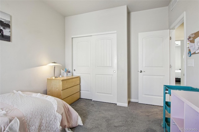 carpeted bedroom with baseboards and a closet