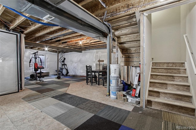 unfinished basement with stairway and visible vents