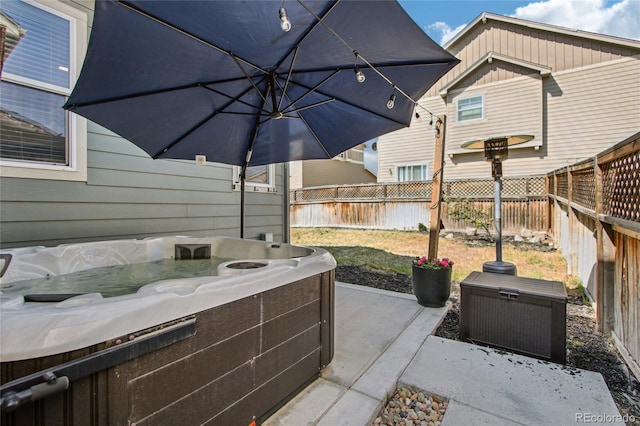 view of patio featuring a fenced backyard and a hot tub