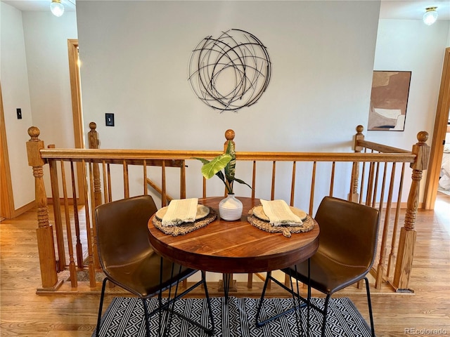 dining area featuring light wood-style floors and baseboards