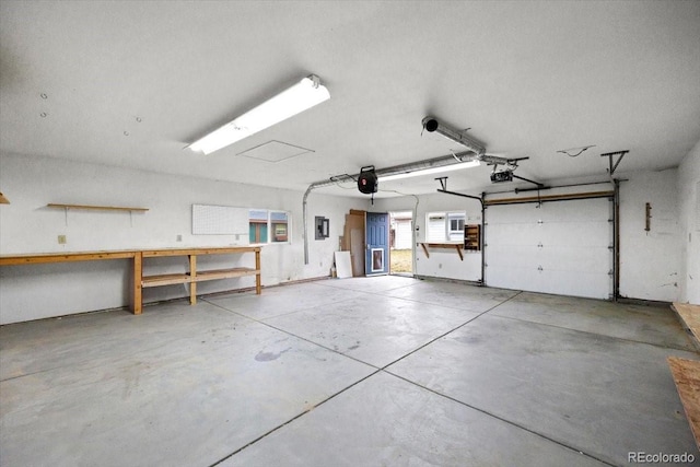 garage with electric panel and a garage door opener