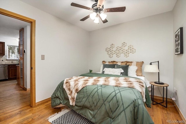 bedroom featuring light wood finished floors, ceiling fan, and baseboards