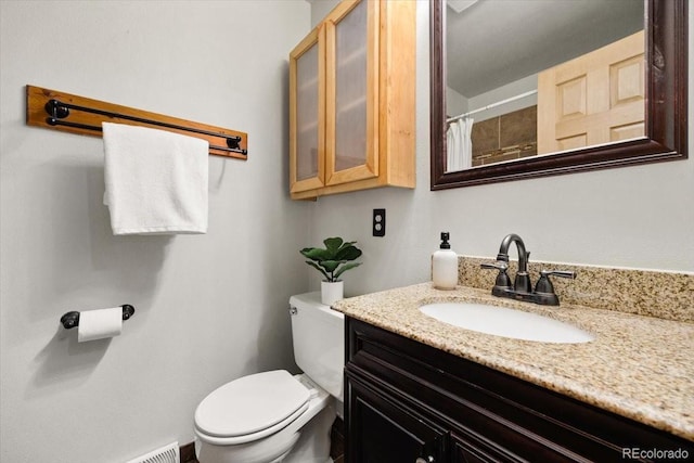 full bathroom featuring toilet and vanity