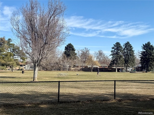 surrounding community featuring a lawn and fence