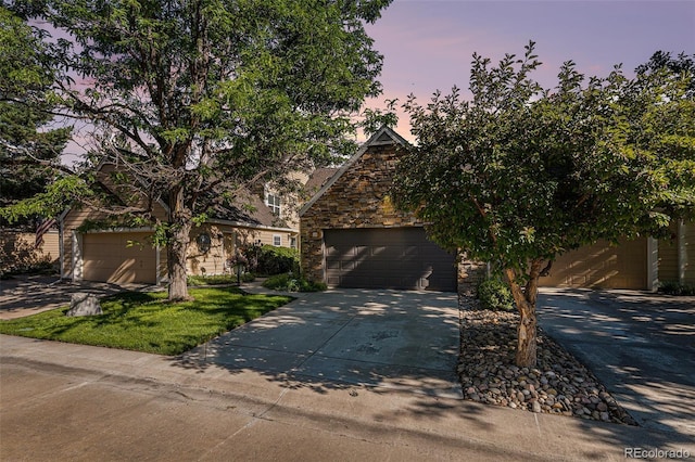 10000 E Yale Ave Unit 58, Denver, CO 80231 - view of property hidden behind natural elements with stone siding and concrete driveway