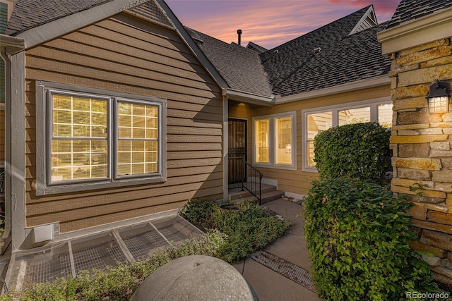 10000 E Yale Ave Unit 58, Denver, CO 80231 - exterior entry at dusk featuring roof with shingles