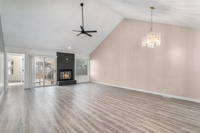 10000 E Yale Ave Unit 58, Denver, CO 80231 - unfurnished living room with wood finished floors, a chandelier, a ceiling fan, high vaulted ceiling, and a large fireplace