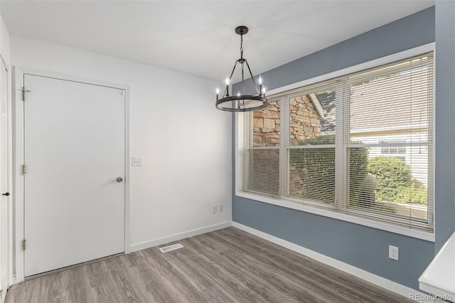 10000 E Yale Ave Unit 58, Denver, CO 80231 - unfurnished dining area featuring a chandelier and wood finished floors
