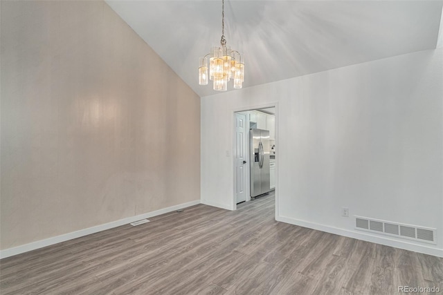10000 E Yale Ave Unit 58, Denver, CO 80231 - unfurnished room with wood finished floors, a chandelier, and lofted ceiling