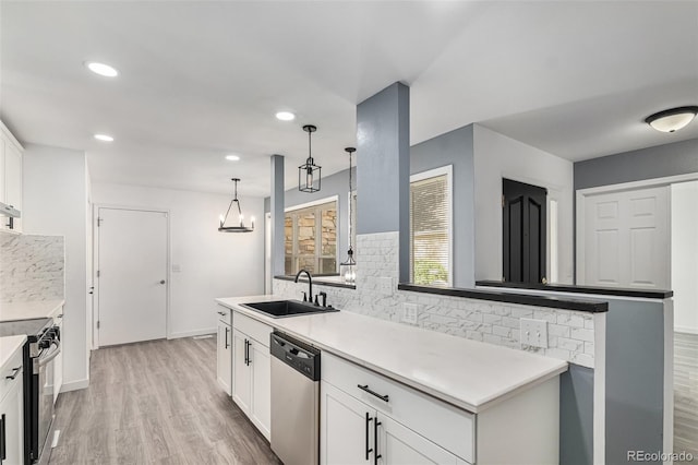10000 E Yale Ave Unit 58, Denver, CO 80231 - kitchen with appliances with stainless steel finishes, backsplash, light wood-style flooring, white cabinetry, and recessed lighting