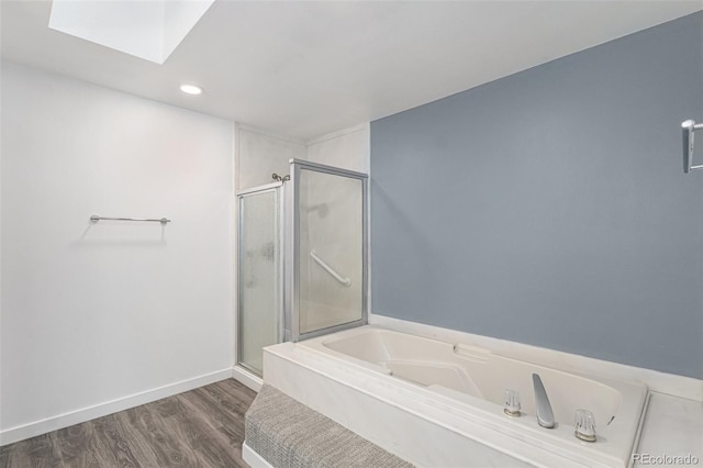 10000 E Yale Ave Unit 58, Denver, CO 80231 - bathroom with a stall shower, a garden tub, a skylight, wood finished floors, and recessed lighting