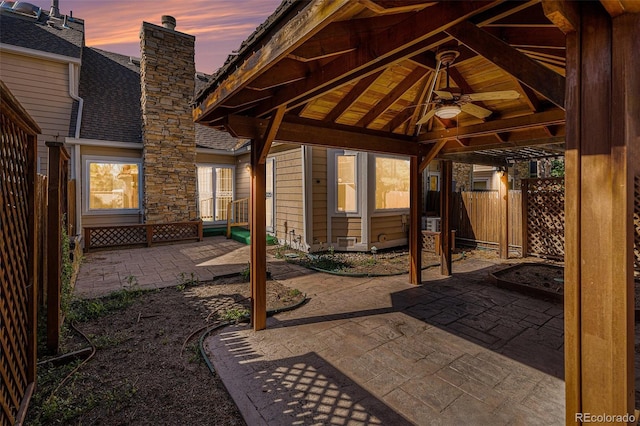 10000 E Yale Ave Unit 58, Denver, CO 80231 - patio terrace at dusk featuring a ceiling fan and a patio