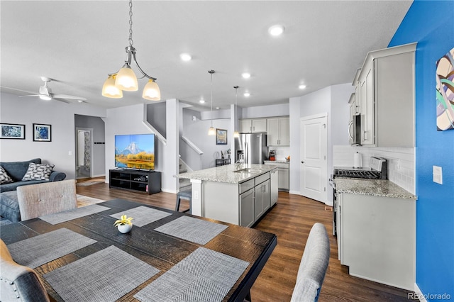 2144 Rosette Ln, Castle Rock, CO 80104 - dining room featuring stairway, dark wood-style flooring, a ceiling fan, recessed lighting, and baseboards