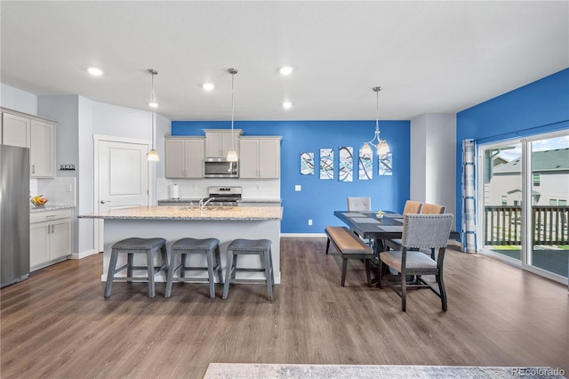 2144 Rosette Ln, Castle Rock, CO 80104 - kitchen with stainless steel appliances, dark wood finished floors, tasteful backsplash, and recessed lighting
