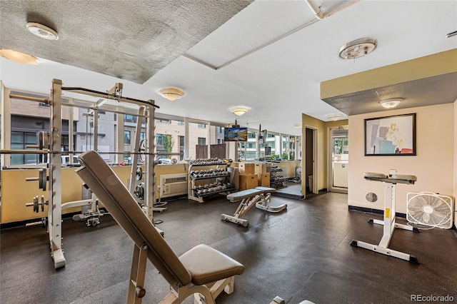 exercise room featuring a textured ceiling